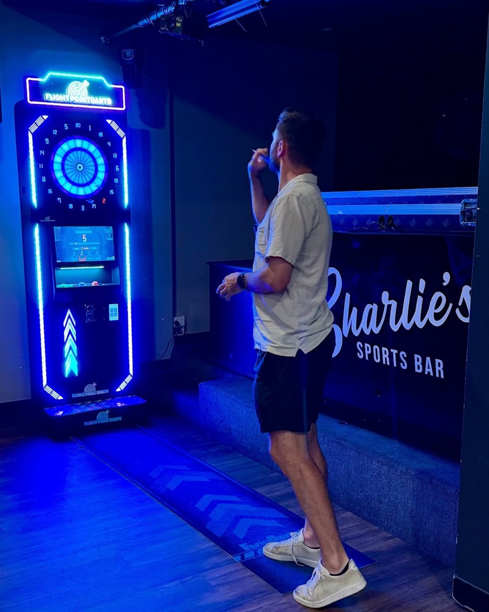 Customer playing darts at Charlie's Sports Bar Perth